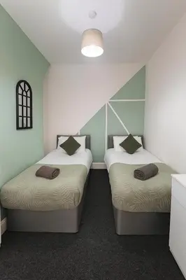 two beds in a room with blue walls at 4-Bedroom House sleeps 9 in Liverpool Perfect for Contractors - Free Parking - Fast WiFi - Fully Equipped Kitchen - Hosted by By Hinkley Homes Short Lets & Serviced Accommodation in Liverpool