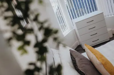 a room with a bed with pillows and a window at 4-Bedroom House sleeps 9 in Liverpool Perfect for Contractors - Free Parking - Fast WiFi - Fully Equipped Kitchen - Hosted by By Hinkley Homes Short Lets & Serviced Accommodation in Liverpool