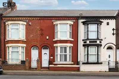 a red brick house with white doors and windows at 4-Bedroom House sleeps 9 in Liverpool Perfect for Contractors - Free Parking - Fast WiFi - Fully Equipped Kitchen - Hosted by By Hinkley Homes Short Lets & Serviced Accommodation in Liverpool