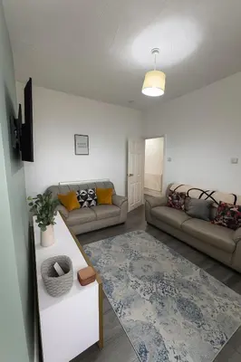 a living room with two couches and a rug at 4-Bedroom House sleeps 9 in Liverpool Perfect for Contractors - Free Parking - Fast WiFi - Fully Equipped Kitchen - Hosted by By Hinkley Homes Short Lets & Serviced Accommodation in Liverpool