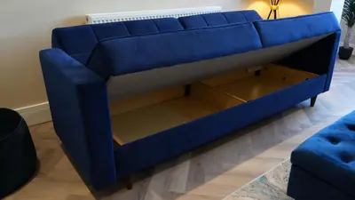a blue couch in a living room at Five Apartments in Blackpool