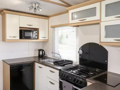 a kitchen with a stove and a sink at The Maples in Millom