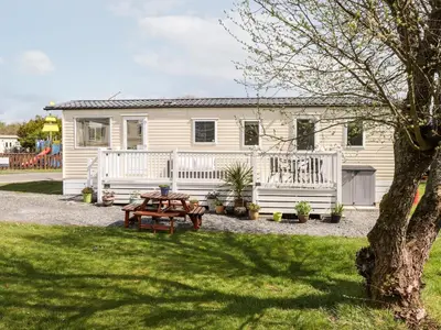 a house with a picnic table in front of it at The Maples in Millom
