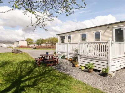 a house with a picnic table in front of it at The Maples in Millom