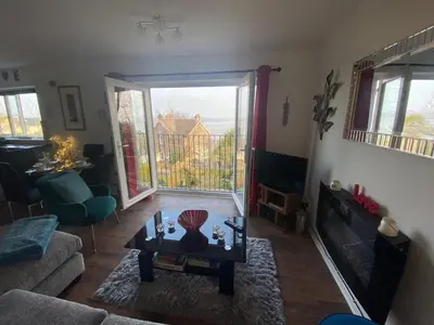 a living room with a couch and a coffee table at SANDYVIEWS in Grange Over Sands