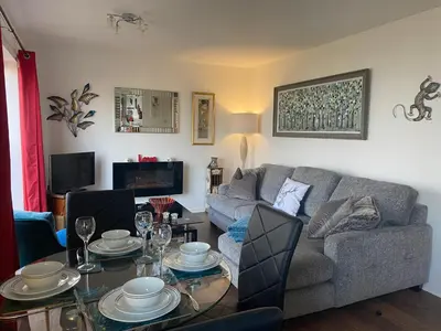 a living room with a couch and a table at SANDYVIEWS in Grange Over Sands