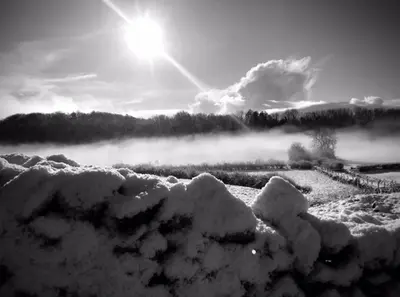 a black and white photo of a field covered in snow at SANDYVIEWS in Grange Over Sands
