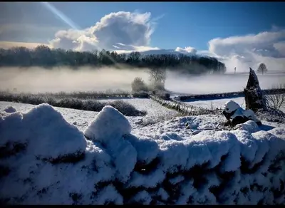 a field covered in snow with fog in the background at SANDYVIEWS in Grange Over Sands