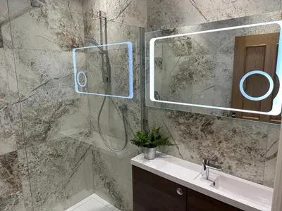a bathroom with a shower and a sink and a mirror at Willshaw Suites for families over 25 only in Blackpool