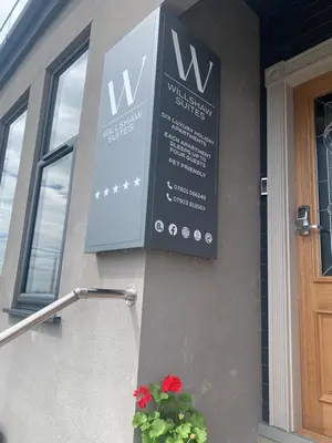 a sign on the side of a building at Willshaw Suites for families over 25 only in Blackpool