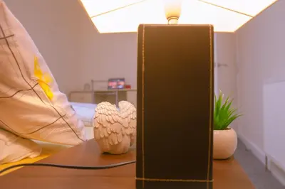 a table with two vases and a lamp on it at Anfield Apartment in Liverpool