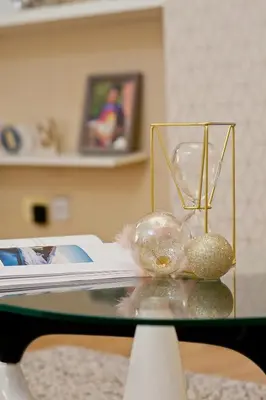 a glass table with a vase and balls on it at Anfield Apartment in Liverpool