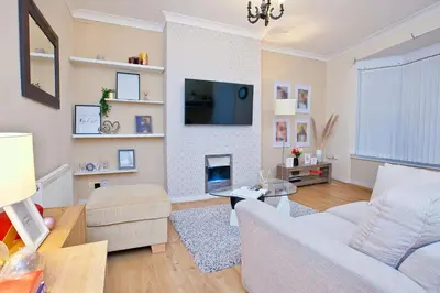 a living room with a couch and a tv at Anfield Apartment in Liverpool