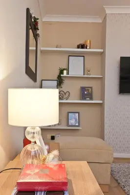 a room with a table with a lamp and a couch at Anfield Apartment in Liverpool