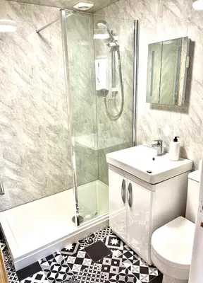 a bathroom with a shower and a sink and a toilet at Beach Sunset in Lytham St Annes