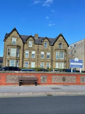 a building with a bench in front of it at Beach Sunset in Lytham St Annes