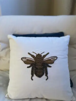 a pillow with a drawing of a bee on it at Avondale, Lytham - Unique and luxury apartment in the heart of Lytham in Lytham St Annes