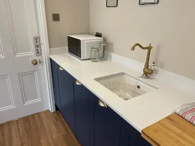 a kitchen counter with a sink and a microwave at Avondale, Lytham - Unique and luxury apartment in the heart of Lytham in Lytham St Annes