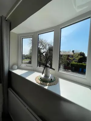 a room with three windows and a vase on a counter at Avondale, Lytham - Unique and luxury apartment in the heart of Lytham in Lytham St Annes