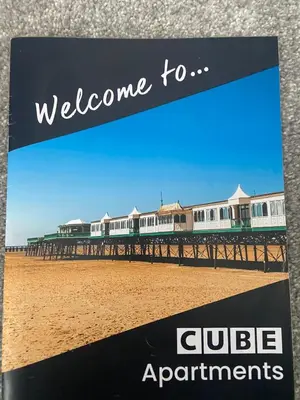 a sign that reads welcome to club apartments on a pier at Cube Apartments in Lytham St Annes