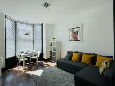 a living room with a couch and a table at Cube Apartments in Lytham St Annes