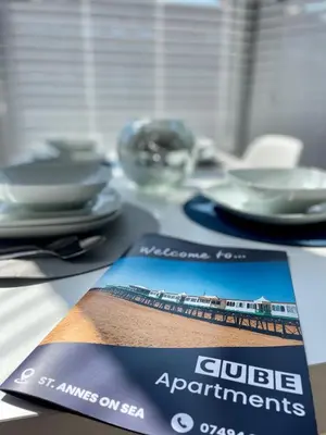 a table with plates and a ticket for a club appointment at Cube Apartments in Lytham St Annes