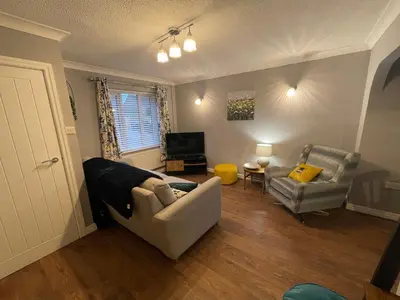 a living room with a couch and a chair at Tranquil 3 bedroom town house with Sky Glass in Thornton