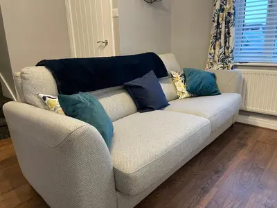 a couch with pillows on it in a living room at Tranquil 3 bedroom town house with Sky Glass in Thornton
