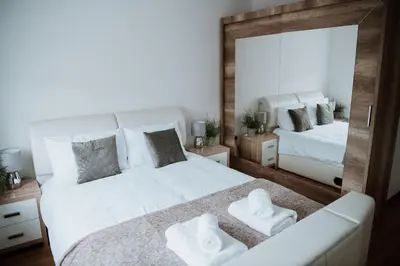a bedroom with a large white bed and a mirror at Flat 5 Lovely 1-bedroom flat in Liverpool in Liverpool