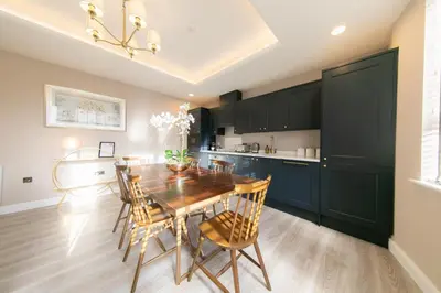 a kitchen with a dining room table and chairs at The Old Bank Apartments in Blackpool