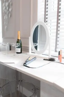 a white counter with a mirror and a bottle of wine at The Old Bank Apartments in Blackpool