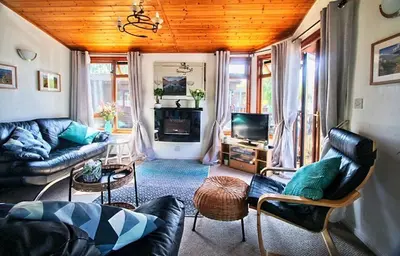 a living room with a couch and a tv at Dot's Place 1 in Carnforth