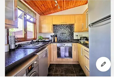 a kitchen with a sink and a stove top oven at Dot's Place 1 in Carnforth