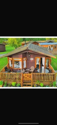 a large house with a wooden fence in front of it at Dot's Place 1 in Carnforth