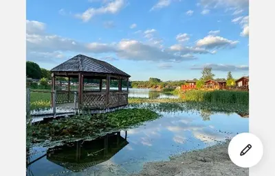 a gazebo next to a body of water at Dot's Place 1 in Carnforth