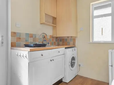 a kitchen with a sink and a washing machine at Beautiful 3 Bed Cottage in the Heart of Flookburgh - Pass the Keys in Grange Over Sands