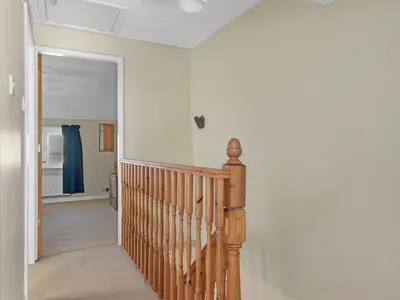 a hallway with a wooden staircase in a home at Beautiful 3 Bed Cottage in the Heart of Flookburgh - Pass the Keys in Grange Over Sands