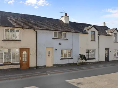 a group of houses on the side of a street at Beautiful 3 Bed Cottage in the Heart of Flookburgh - Pass the Keys in Grange Over Sands