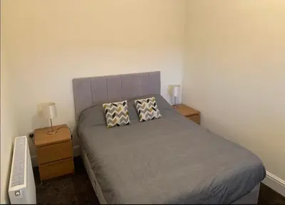 a bedroom with a bed with two pillows on it at Salcombe Holiday Cottage in Wilpshire