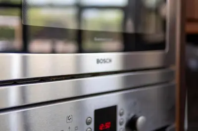 two stainless steel microwaves sitting next to each other at Abbey Farm House Ormskirk in Ormskirk