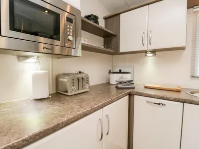 a kitchen with a counter top with a microwave at Number 10 in Carnforth