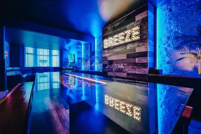 a swimming pool in a room with blue lights at BREEZE BLACKPOOL LUXURY SUITES in Blackpool