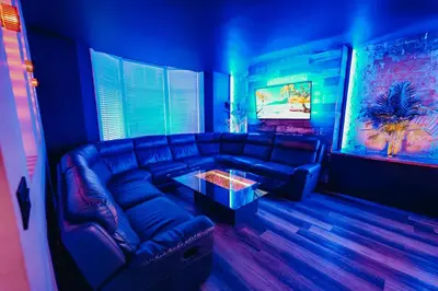 a blue living room with a couch and a table at BREEZE BLACKPOOL LUXURY SUITES in Blackpool