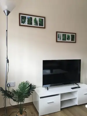 a living room with a flat screen tv on a white entertainment center at Modern 1 bedroom flat perfect for match or city break in Liverpool