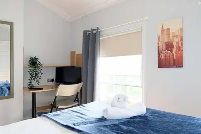 a room with a bed with a towel animal on it at Seymour Townhouse by Serviced Living Liverpool in Liverpool
