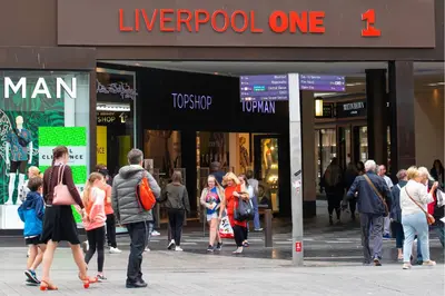 a group of people walking in front of a store at Seymour Townhouse by Serviced Living Liverpool in Liverpool