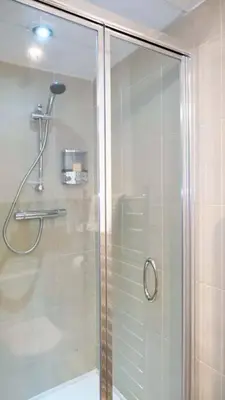 a shower with a glass door in a bathroom at Seymour Townhouse by Serviced Living Liverpool in Liverpool