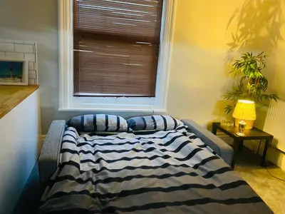a bed in a room with a window at 1 bedroom spacious apartment in Lytham St Annes
