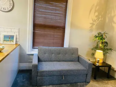 a chair sitting in a room with a window at 1 bedroom spacious apartment in Lytham St Annes