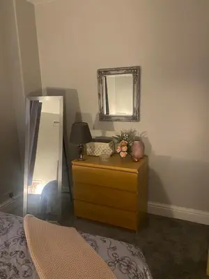 a bedroom with a dresser and a mirror and a bed at 1 bedroom spacious apartment in Lytham St Annes